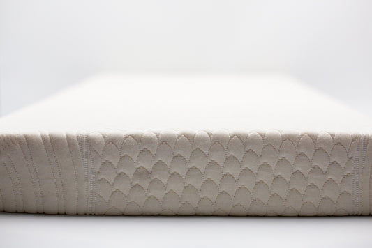 2-inch organic latex mattress topper with GOTS-certified cotton cover on queen bed