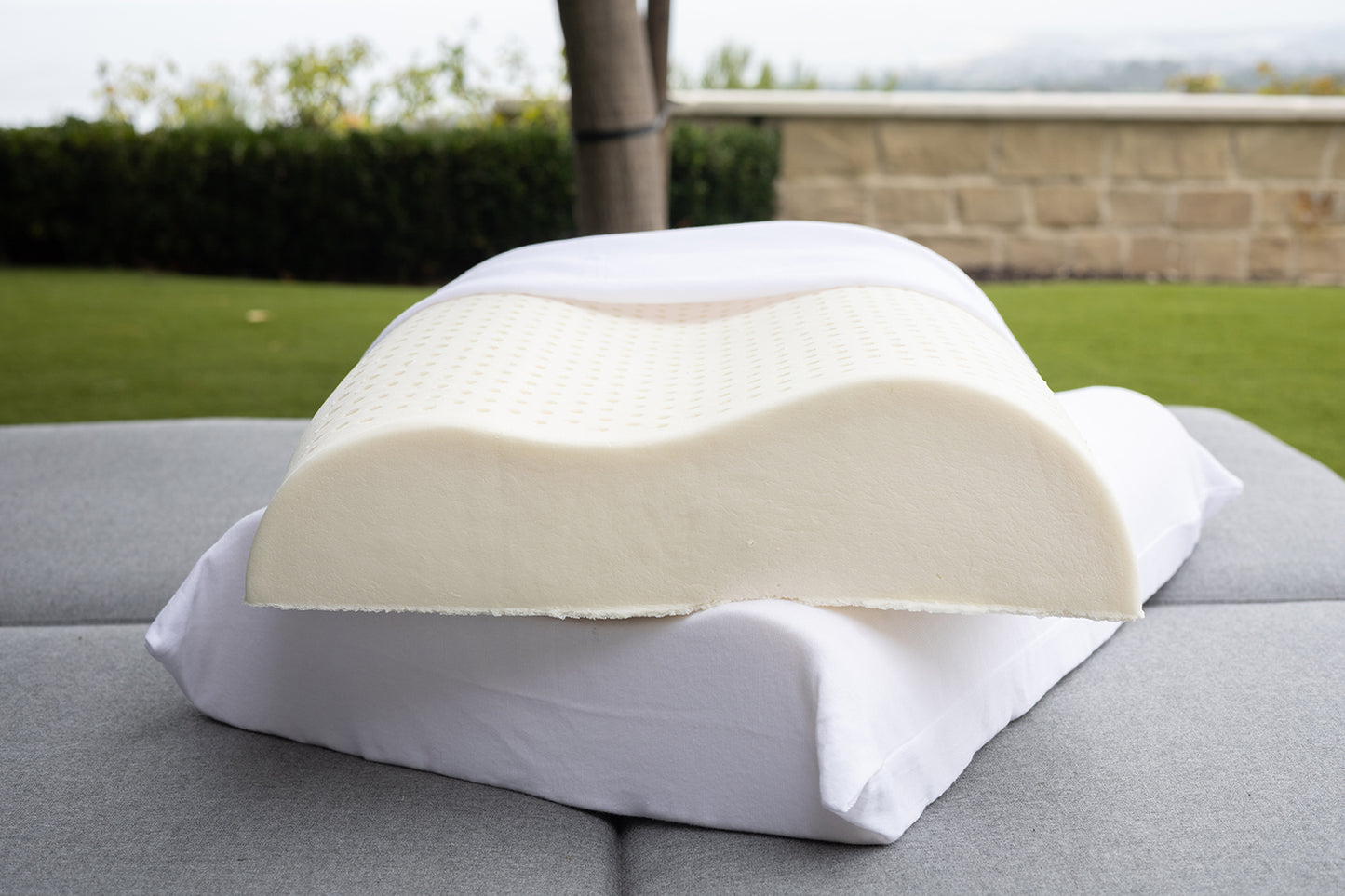 side view of the low and high loft of the contour pillow showing the ergonomics of the latex foam. along with gots certified cotton cover