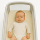 Dunlop Latex crib mattress topper packaging with bamboo text and baby illustration on a white background